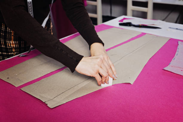 istock Female fashion designer tailor making sewing patterns at workplace in sewing studio. Seamstress working 1435900823
