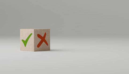 pros and cons concept. Wooden block with image of pros versus cons. Tick mark and cross mark x on wooden cubes. Concept of positive or negative decision making or choice of approval or rejection.