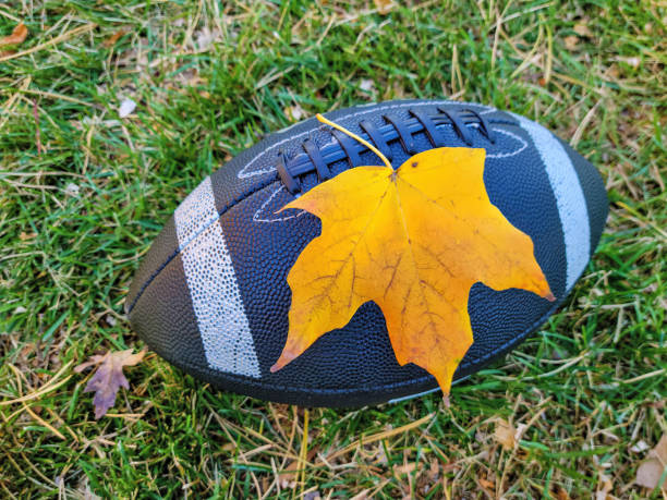 istock Yellow Maple Leaf On Football 1435902370