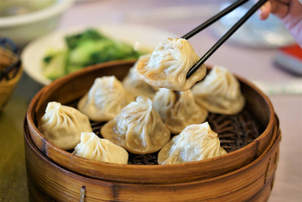 istock Xiao Long Bao in chopsticj, Streamed Pork Dumplings (Selective Focus) 1435903190