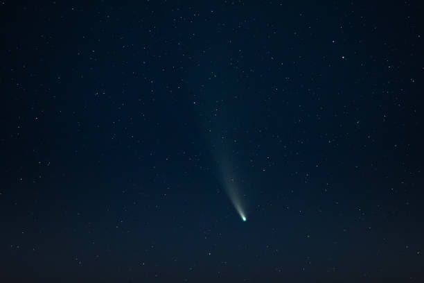 istock Comet in night sky. Summer starry sky. Stars. Long exposure. Atmospheric landscape. Comet Neowise. Meteor 1435904573