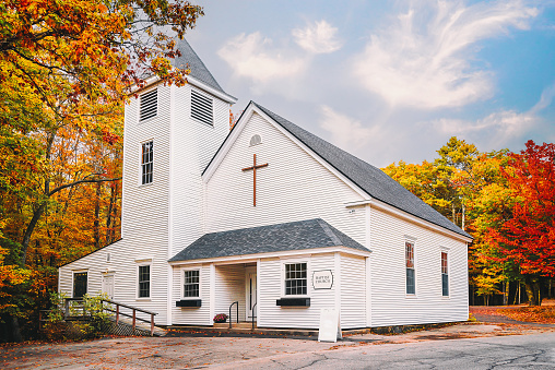 Autumn sugar maple and country church in Vermont