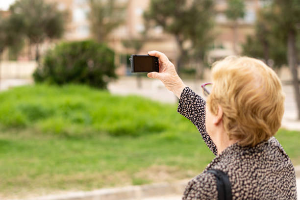 istock Elderly woman using action camera outdoors 1435905268