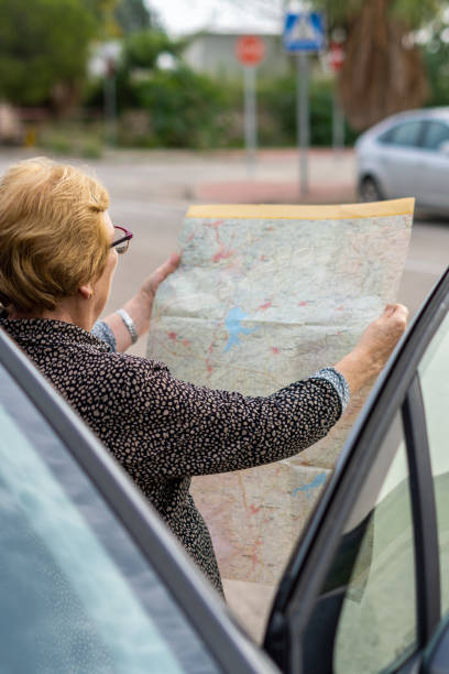 istock Senior woman searching direction map 1435905309