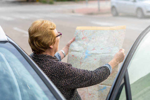 istock Senior woman searching direction map 1435905316