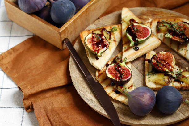 Fig toast with cheese, olive oil, spices and balsamic vinegar. Bruschetta with figs. stock photo