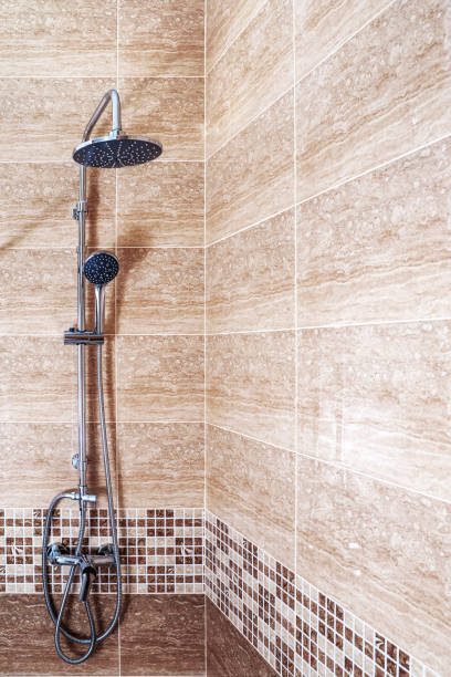 istock rain shower system faucet on empty clean marble wall in a bathroom , morning sunlight, beautiful  shadow. Space, Mock up, Background. 1435906357