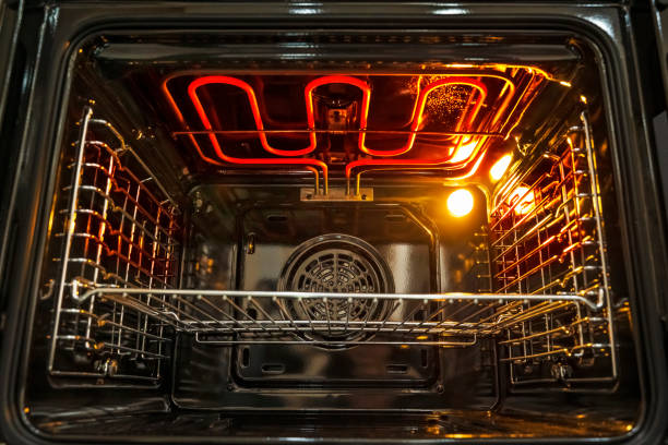 istock Oven. Empty hot oven with red a flaming grill 1435907087