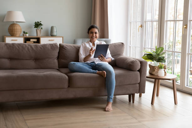 istock Young Indian woman spend time at home using tablet device 1435907693