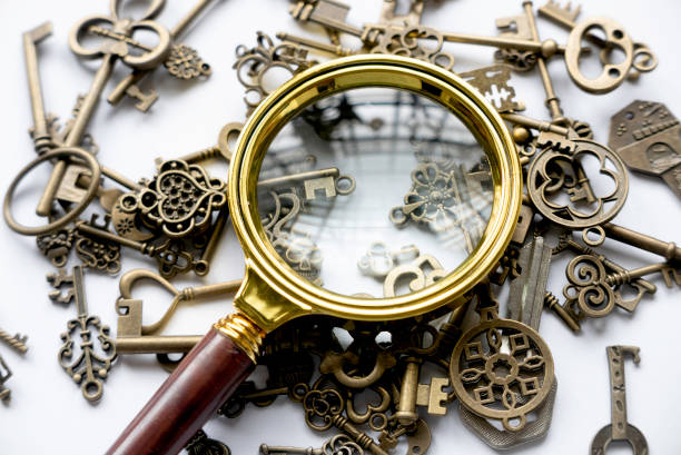 Magnifying glass and a bunch of keys. Concept of search for solution. stock photo