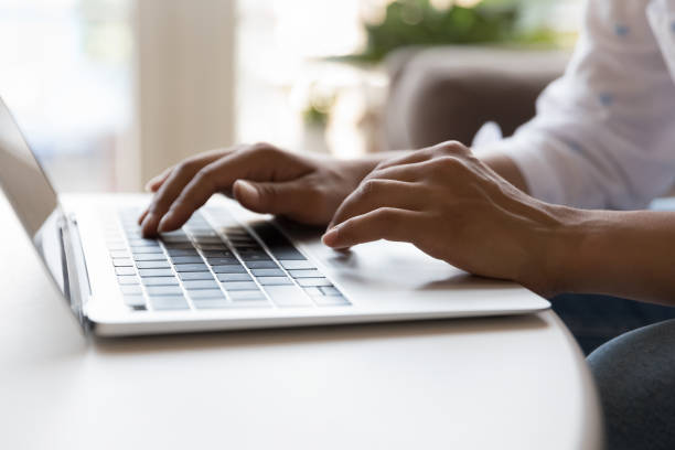istock Close up view unknown female hands on laptop keyboard 1435907771