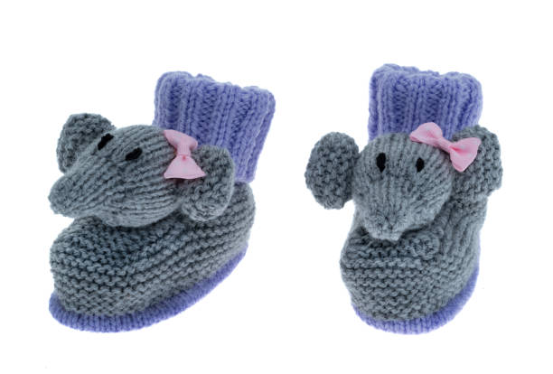 Soft pink slippers rest on the warm wooden floor by the curtain-draped window.