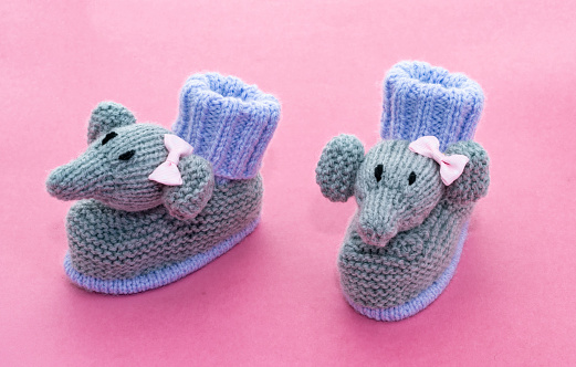 Knitted baby elephant booties - pink background