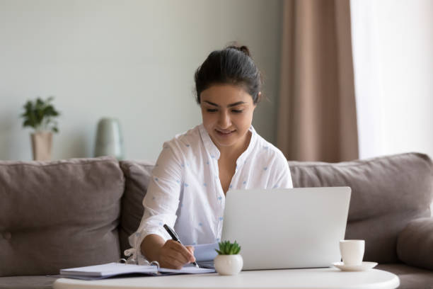 istock Indian woman writing in personal diary while work or studying 1435912294