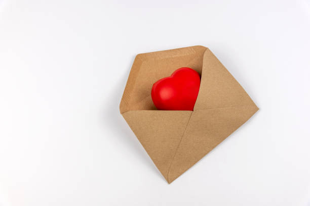 Heart shape in a brown envelope on white background