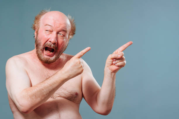 istock Front view elderly man stand from left looking to left pointing right index fingers of both hands. 1435914257