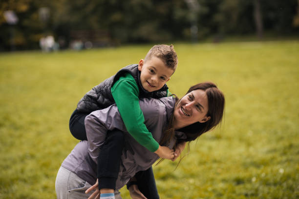 istock Young mother playing around with her son in the park 1435915227