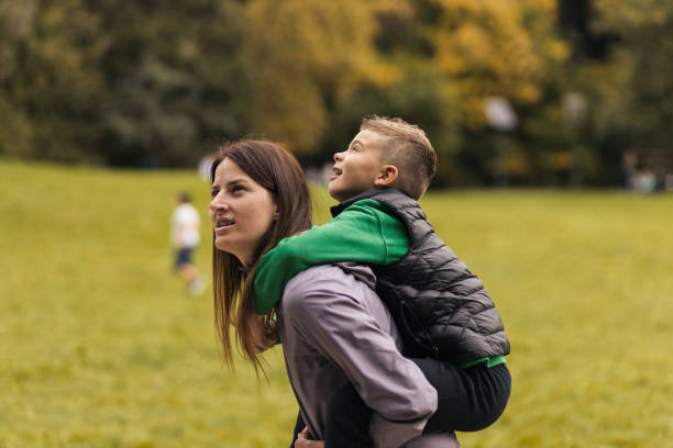 istock Young boy piggybacking on his mothers back 1435915407