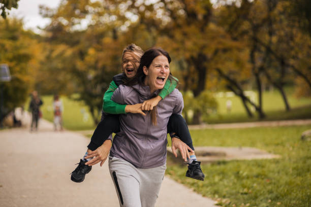 istock Mother running with her son on her back 1435915542