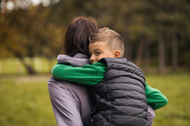 istock Mother and son having fun in the park 1435915548