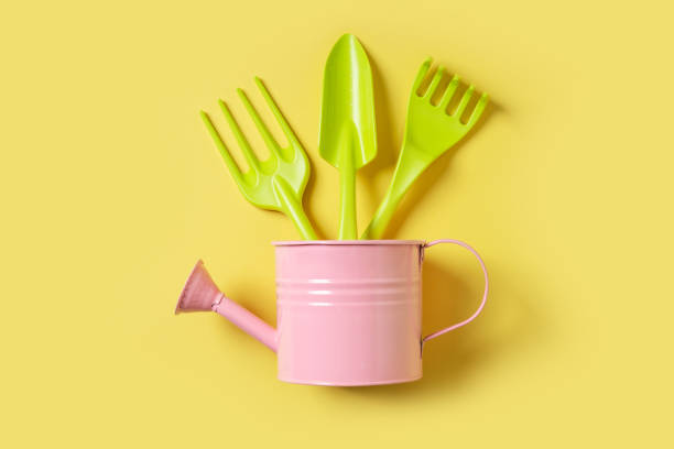 istock Growth and gardening creative concept with colors tools on yellow background, 1435915551