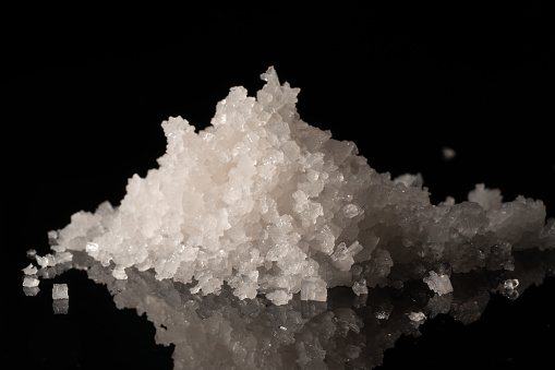 Sea salt grain on a dark background