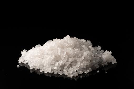 Sea salt grain on a dark background