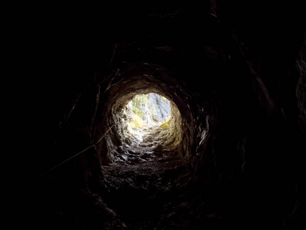 istock Bright light shining at the end of a cave, Slovenia 1435919026