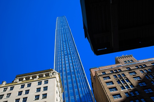 New York, NY, USA - Oct 23, 2022: Steinway Tower at 111 W 57th St shown under a bright blue sky as viewed from the ground.
