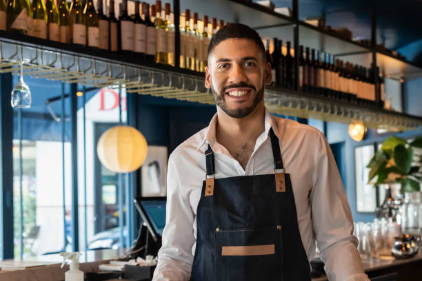 istock Portrait of a smiling bartender looking at camera 1435925942