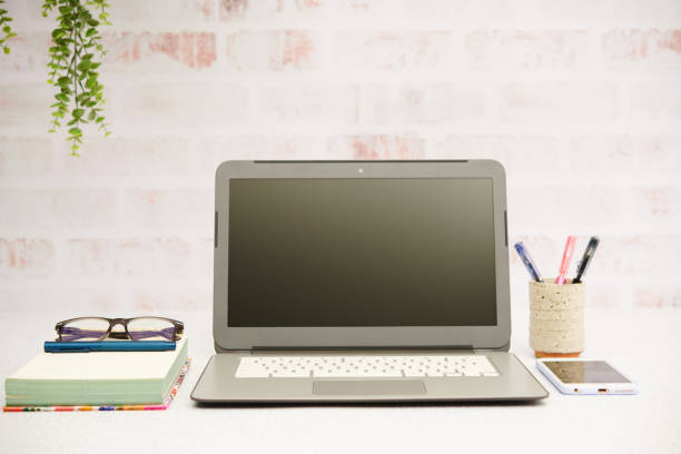 Business still life with laptop and smart phone in bright office setting
