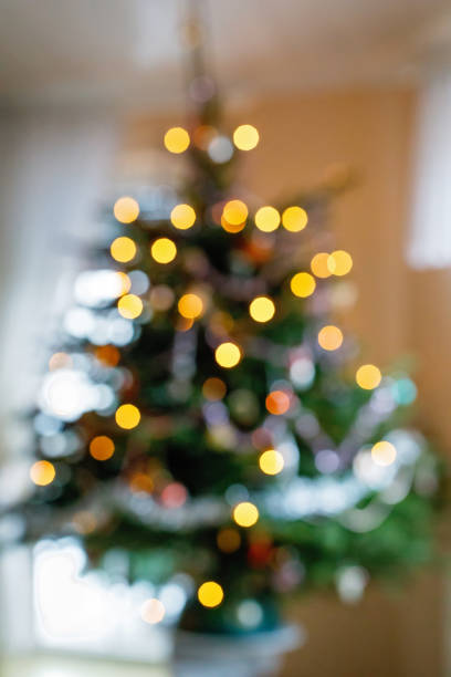 istock Bokeh lights illumination on decorated Christmas tree. Xmas holiday. 1435930435