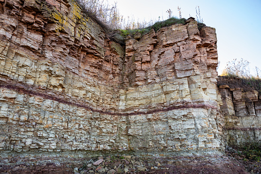 Ilmensky Glint is a natural formation, a geological monument on the southern shore of Lake Ilmen. Sheer wall of sedimentary rocks of different colors.