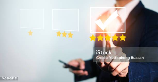 Businessman Touching Checkmark In The Box Highest Satisfaction Rating Is Five Stars Yellow Star Checkbox Mark One Star To Five Star Rating Evaluation And Customer Satisfaction Reviews Stock Photo - Download Image Now