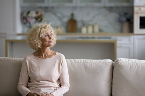 istock Thoughtful attractive blond middle-aged woman staring into distance 1435937476
