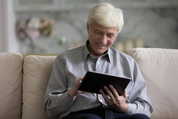 istock Older man spends leisure use digital tablet 1435937479