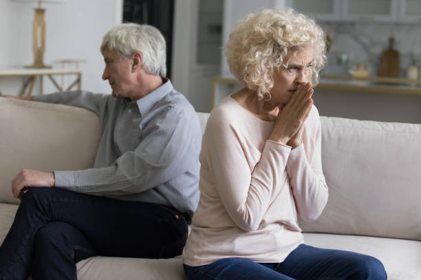 istock Older couple sit apart in couch feel dissatisfied with relations 1435937501