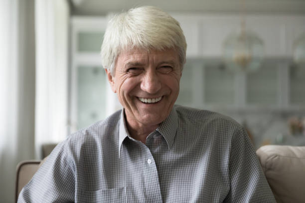 istock Happy senior man laughing staring at camera, headshot 1435937695