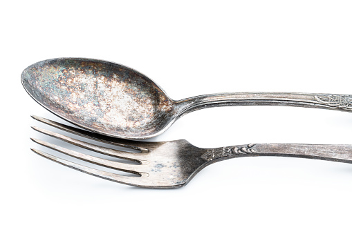 Vintage  tarnisheddinner silver spoon and fork isolated on white background