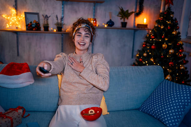 istock Cheerful woman watching television 1435939207