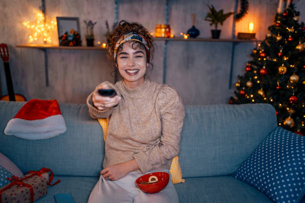 istock Cheerful woman watching television 1435939296