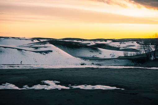 A beautiful bright sunset sky over snowy sand dunes in Saint Anthony, Idaho