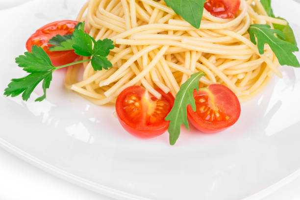 Italian pasta with tomatoes. It is located on a white background. Close-up.