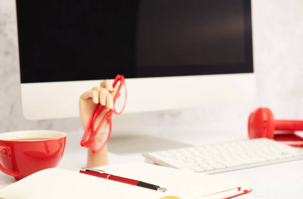 istock Bright office setting with desktop computer and red office supplies 1435948226