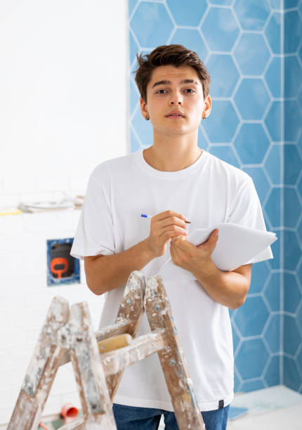 istock Motivated guy taking notes while working on renovation of house 1435948373