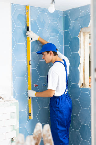 istock Contractor inspecting quality of ceramic tiles laid with level meter 1435948404