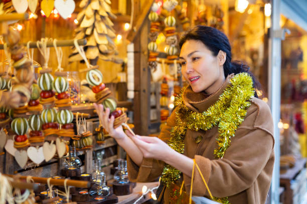 istock Asian female choosing decorations at Christmas fair 1435949437