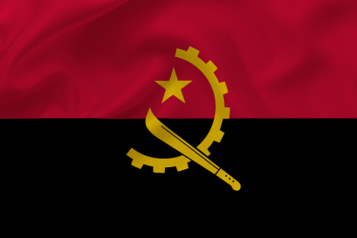 Flag of Angola on waving silk background. Angola national flag.
