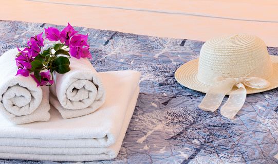 towel and flowers in hotel room