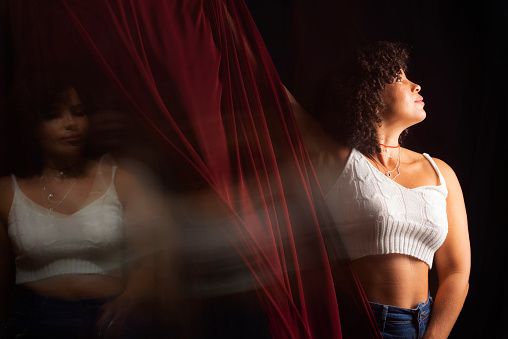 Time lapse view of woman moving a rag. Long exposure, motion blur. Happy woman. Salvador, Brazil.